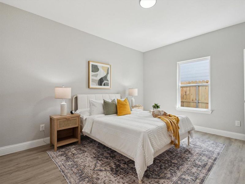 Bedroom with dark hardwood / wood-style flooring