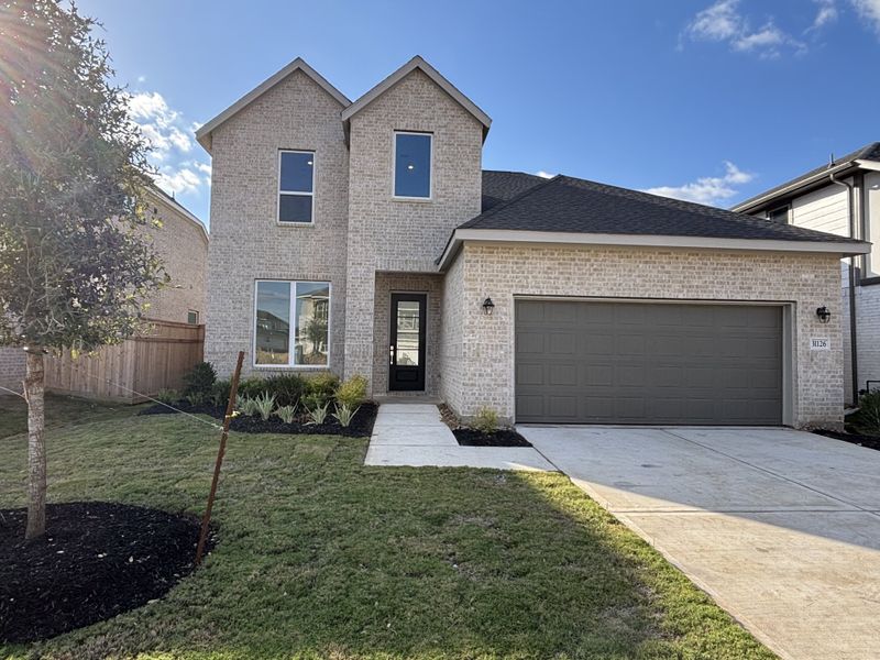 Front exterior of a new home in Cross Creek West: Richmond Collection, Fulshear, TX, highlighting curb appeal (Image 1). Front exterior of a new home in Cross Creek West: Richmond Collection, Fulshear, TX, highlighting curb appeal (Image 1).