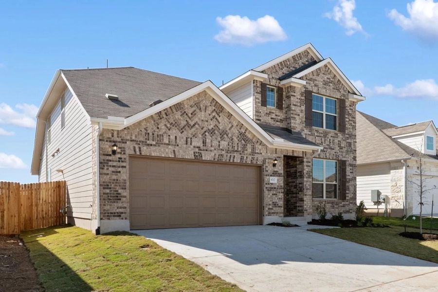 Front exterior of a new home in Willow Springs, Buda, TX, highlighting curb appeal (Image 26).
