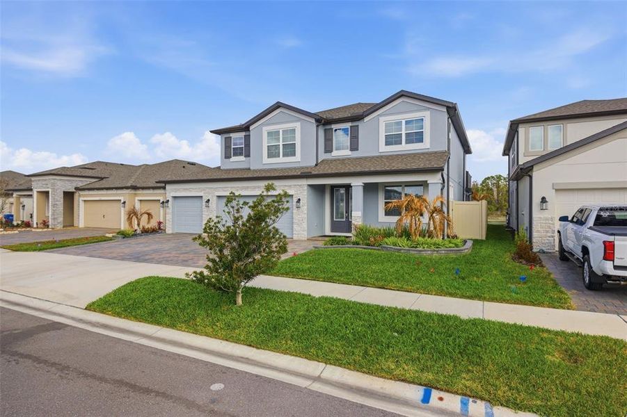 Front exterior of a new home in Whispering Oaks Preserve, Wesley Chapel, FL, highlighting curb appeal (Image 27). Front exterior of a new home in Whispering Oaks Preserve, Wesley Chapel, FL, highlighting curb appeal (Image 27).