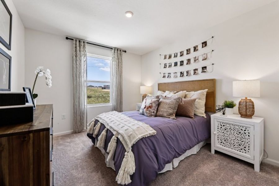 A bedroom with a large window. A bedroom with a large window.