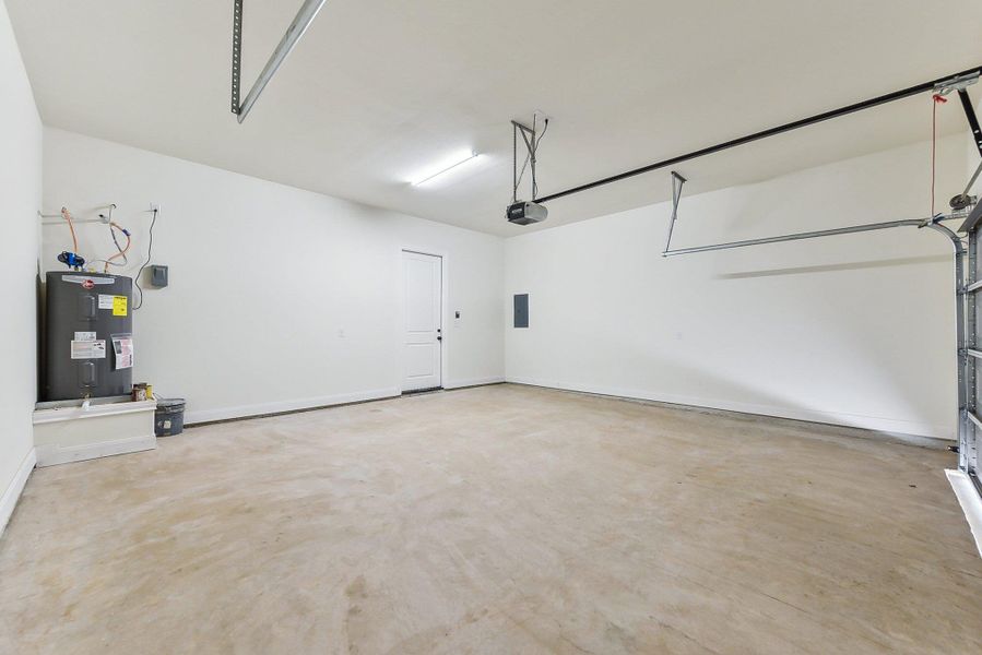 Garage with electric water heater and a garage door opener Garage with electric water heater and a garage door opener