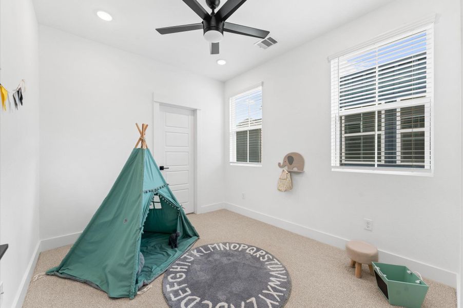 This cozy secondary bedroom offers a peaceful retreat with soft natural light and a versatile layout perfect for guests, a home office, or a growing family. Neutral tones and plush carpeting create a warm, welcoming atmosphere, while a spacious closet and thoughtful lighting add comfort and functionality. Whether styled for rest or productivity, this room adapts beautifully to your needs. Ceiling fans are not included.