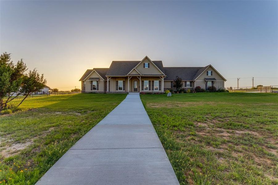 View of front of property featuring a yard, a porch, and board and batten siding