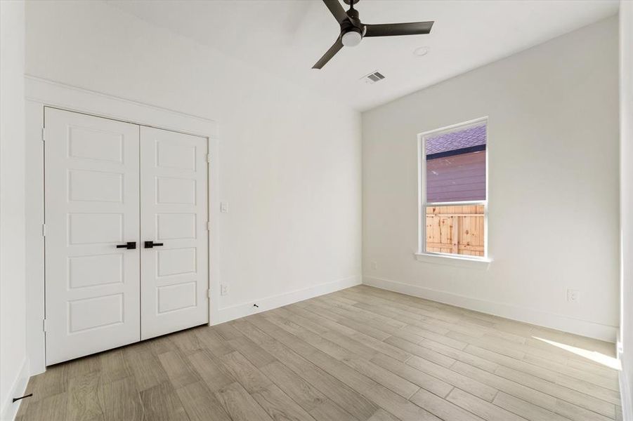 3rd bedroom highlights a ceiling fan, recessed lights and a spacious closet.