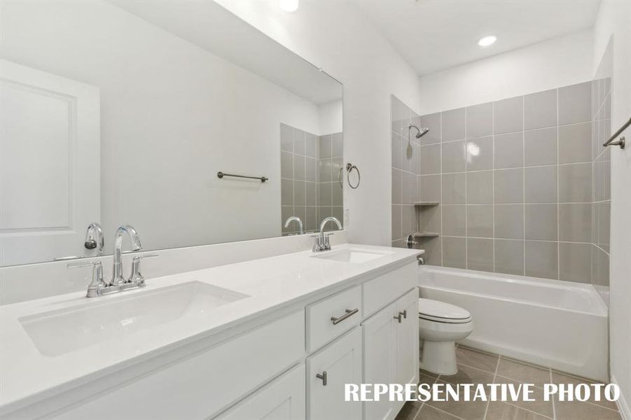 Featuring dual sinks, guests will enjoy their own space in this lovely bath.  REPRESENTATIVE PHOTO