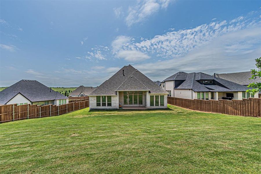 Spacious rear yard with a manicured lawn