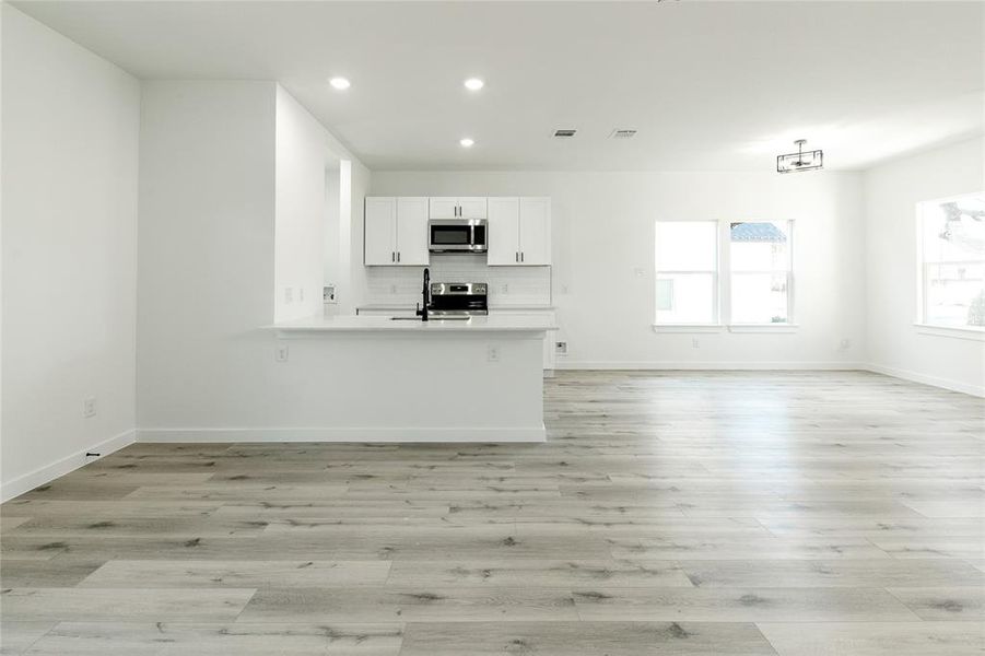 Unfurnished living room featuring sink