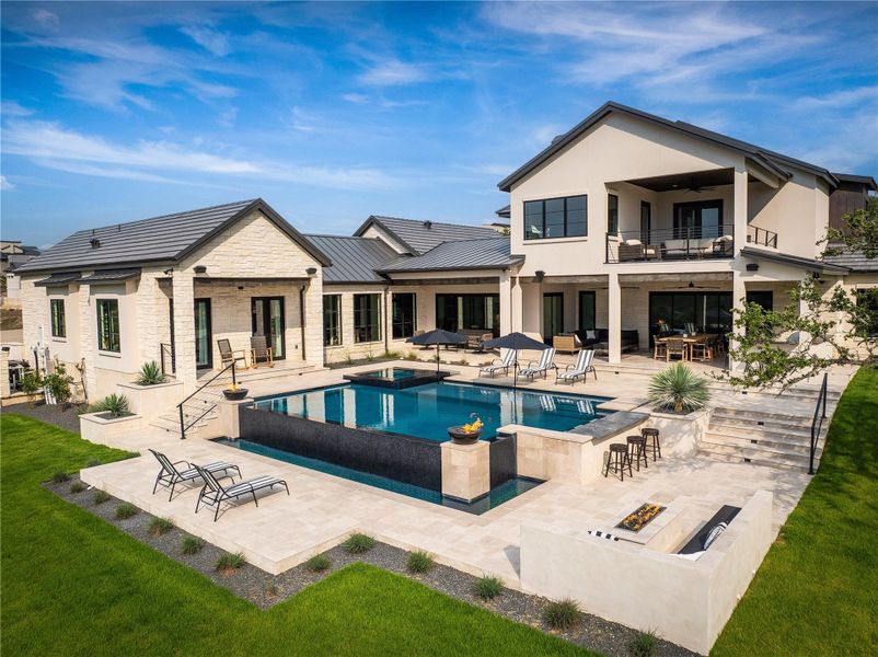 View of swimming pool with a patio area, an in ground hot tub, ceiling fan, and an outdoor fire pit