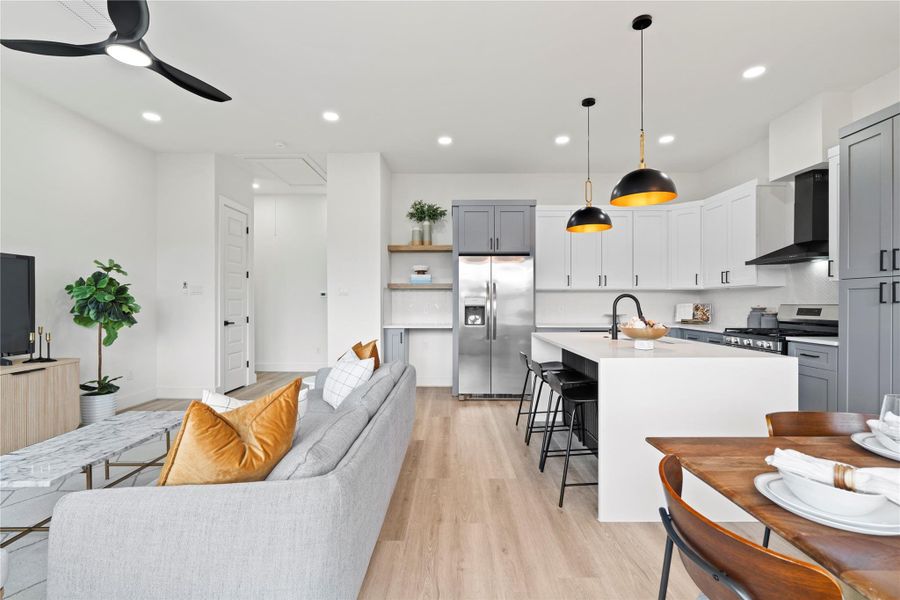 An integrated layout places the kitchen at the center of the action, effortlessly linking to both the dining and living areas.