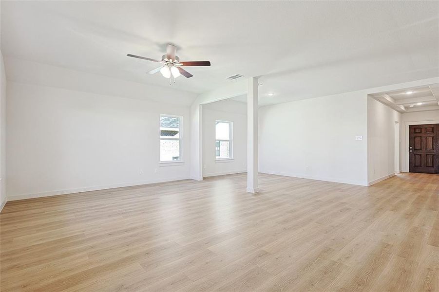 Unfurnished living room with light hardwood / wood-style flooring and ceiling fan