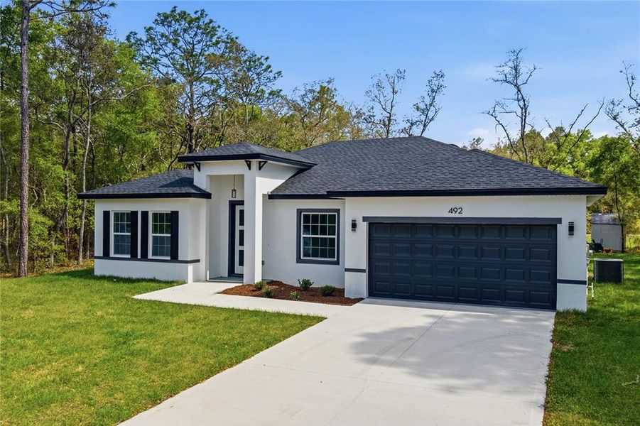 Front exterior of a new home in , Citrus Springs, FL, highlighting curb appeal (Image 17).
