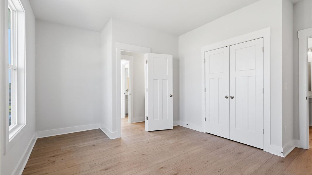 Thoughtfully designed secondary bedroom featuring hardwood flooring and tasteful detail in Seneca, SC