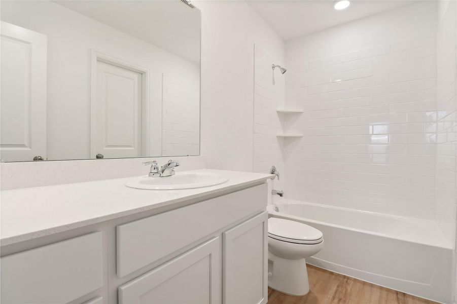 Secondary bathroom has plenty of counter space and tub/shower combination Secondary bathroom has plenty of counter space and tub/shower combination