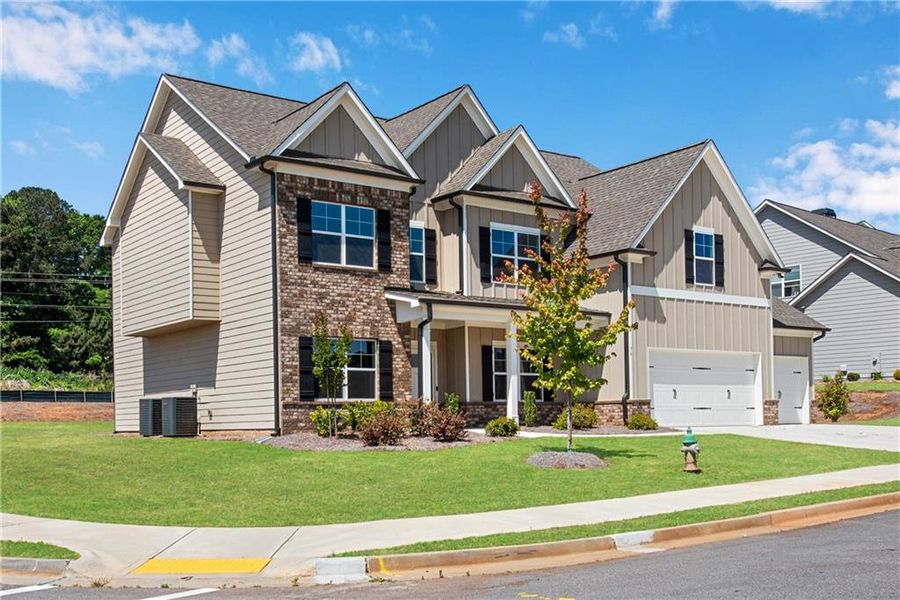 Front exterior of a new home in Hidden Fields, Hoschton, GA, highlighting curb appeal (Image 25).