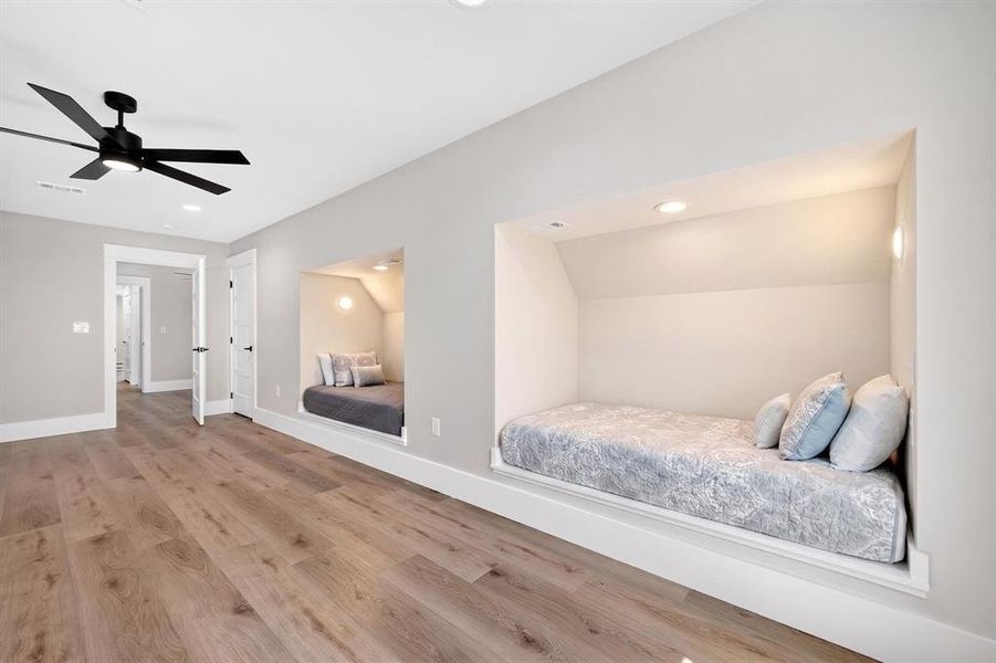 Ultimate destination for large families: Custom-built-in bunk room equipped with four distinct beds. Each nook features a private sconce light and dedicated electrical outlets. Ultimate destination for large families: Custom-built-in bunk room equipped with four distinct beds. Each nook features a private sconce light and dedicated electrical outlets.