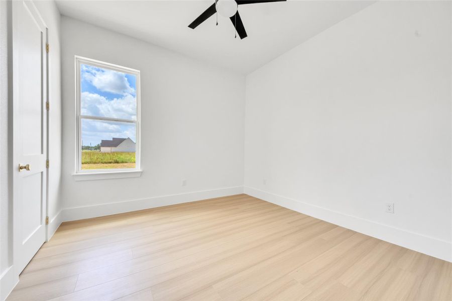 Spacious secondary bedrooms feature large windows that provide abundant natural light and closets with custom built-ins. Spacious secondary bedrooms feature large windows that provide abundant natural light and closets with custom built-ins.