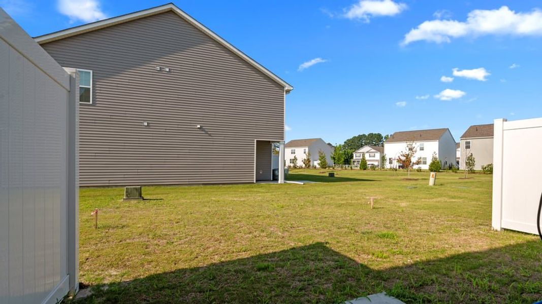 Exterior details and patio area of a home in The Townes at Ridgewood Farms, Winterville (Image 18).