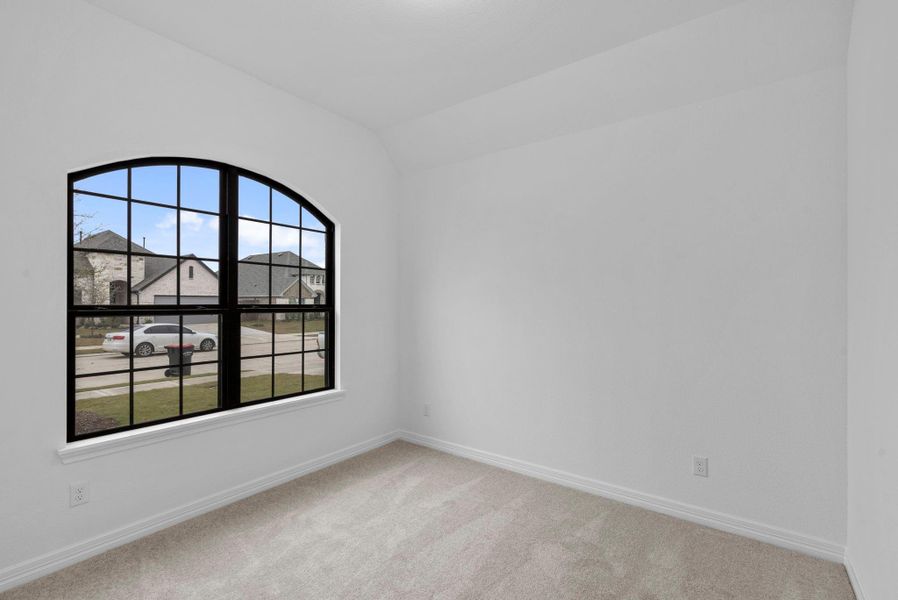 Bedroom two's oversized arched windows make for a statement for a stunning guest room or playful child's room.