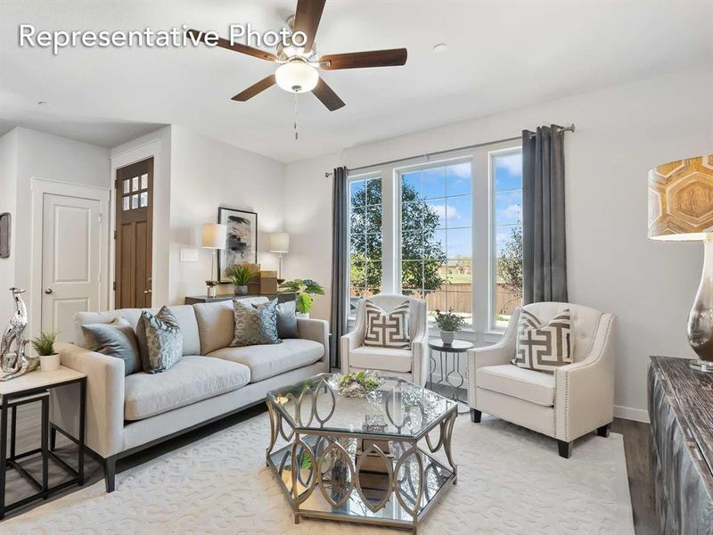 Living room with ceiling fan and light hardwood / wood-style flooring