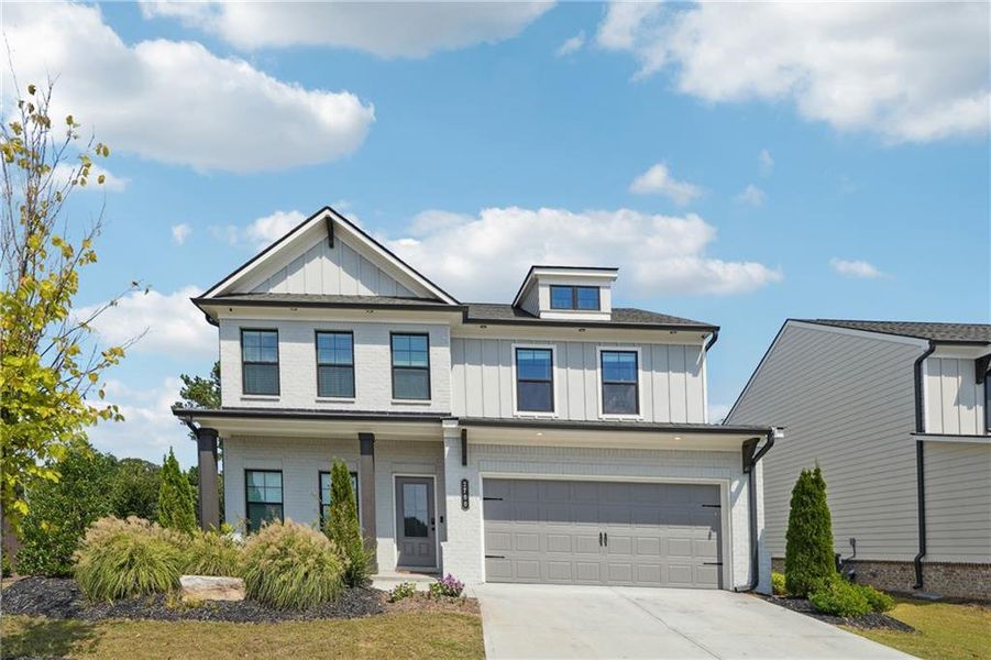 Front exterior of a new home in Westgate Estates, Loganville, GA, highlighting curb appeal (Image 1).