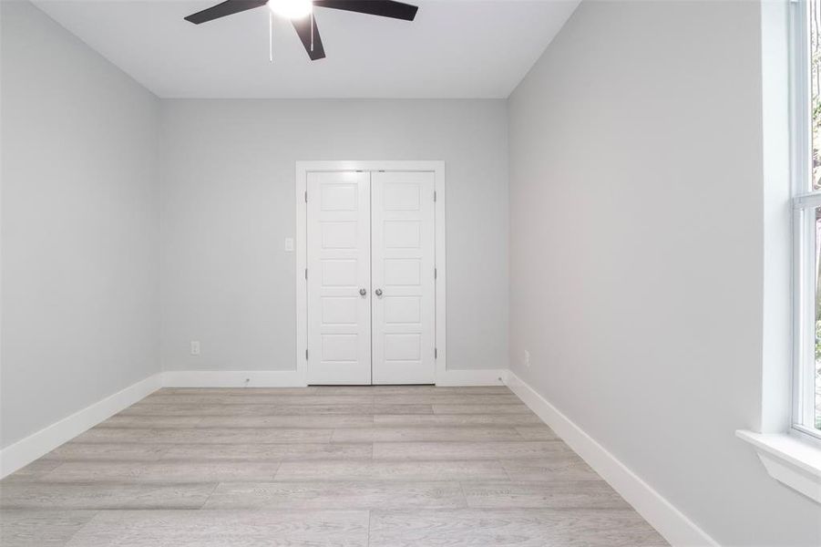 Spare room featuring ceiling fan and light hardwood / wood-style flooring