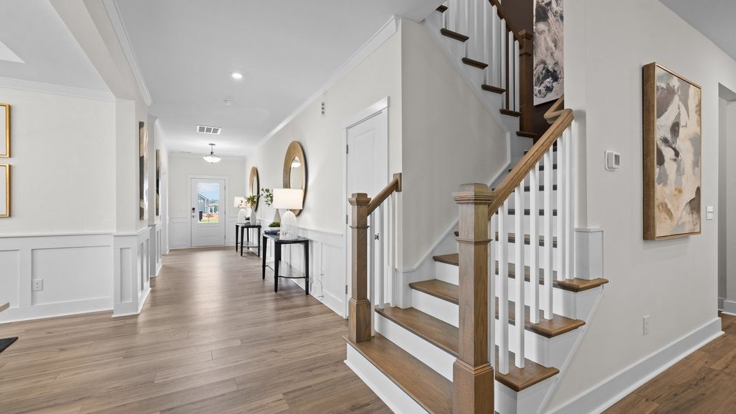 Ample entry foyer and solid oak tread stairs with open rails in the Jordan Design by DRB Homes in York, SC