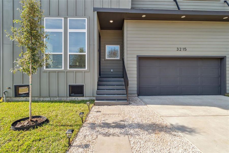 This walkway embodies attention to detail with landscaping, concrete pavers surrounded by Flagstone.