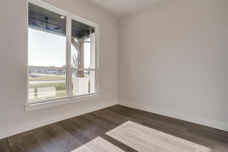 Spare room featuring wood-type flooring