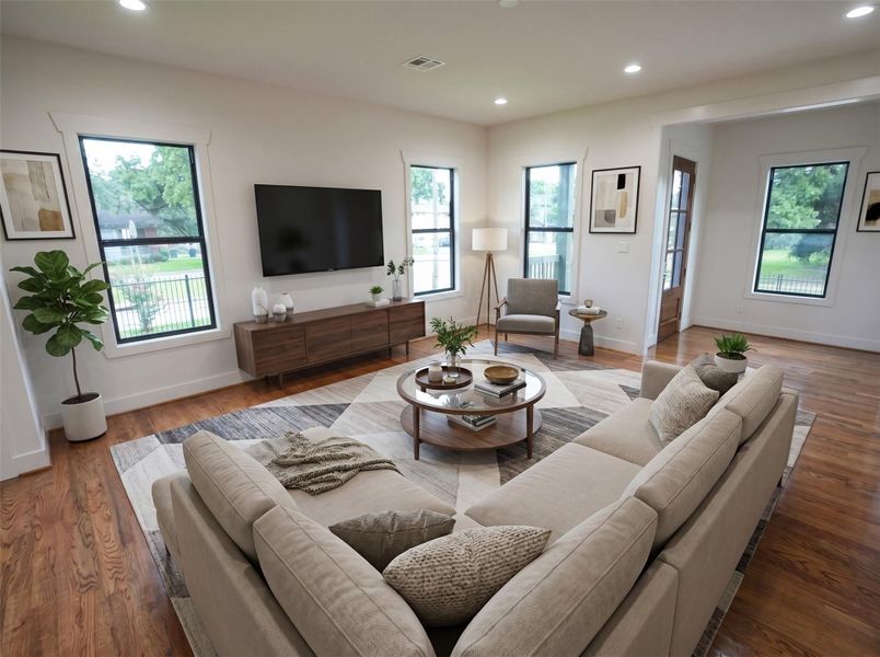 Bright, open, and designed for everyday living. The spacious family room features real hardwood floors, abundant natural light, and an effortless flow into the dining area and kitchen—perfect for relaxing or entertaining.