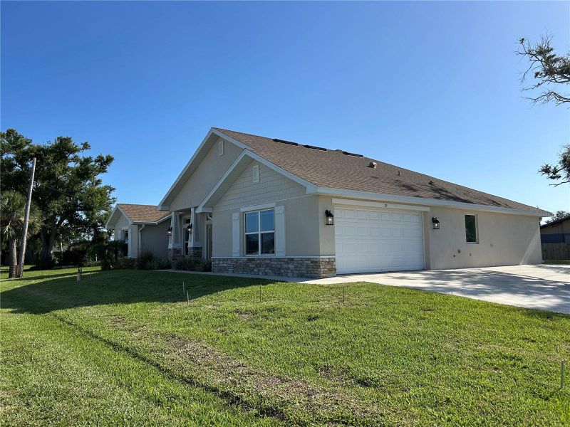 Front exterior of a new home in Venice, Venice, FL, highlighting curb appeal (Image 23).