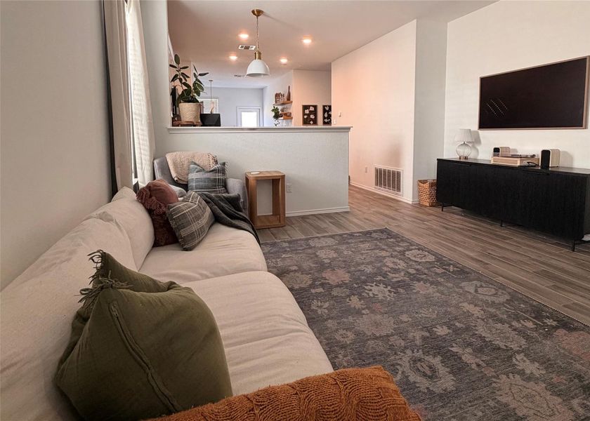 Living area with wood finished floors and recessed lighting Living area with wood finished floors and recessed lighting