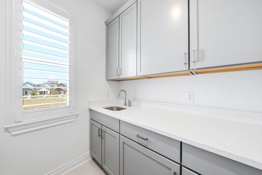 Streamlined cabinetry and solid counters elevate this highly functional workspace. Streamlined cabinetry and solid counters elevate this highly functional workspace.