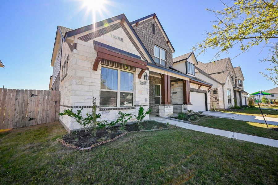 Front exterior of a new home in StoneCreek Estates, Richmond, TX, highlighting curb appeal (Image 27).