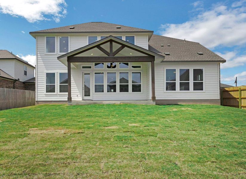Rear view of house with a lawn and a fenced backyard Rear view of house with a lawn and a fenced backyard