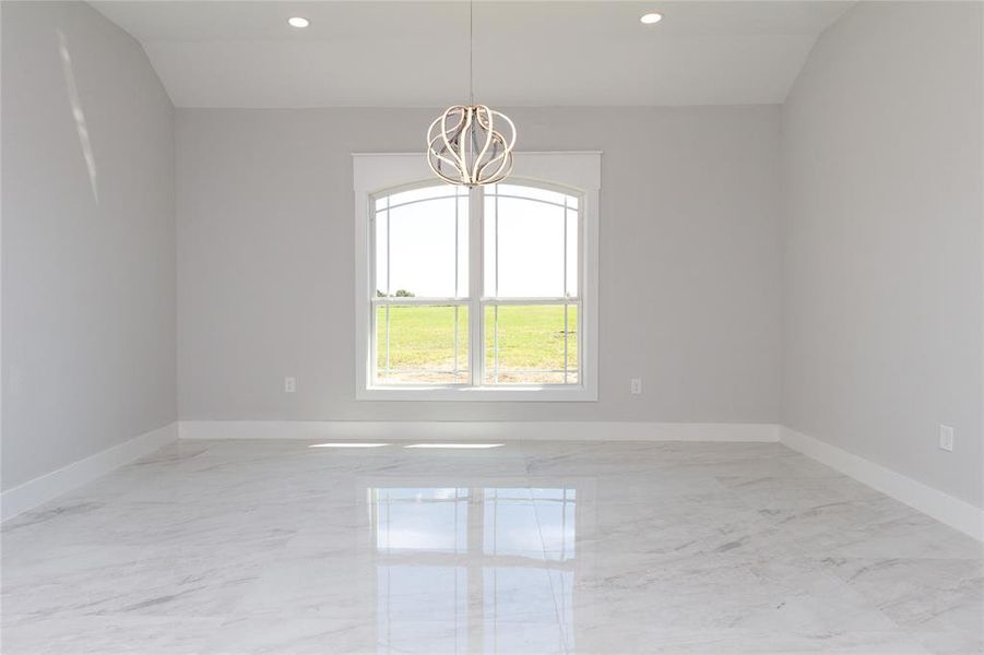 featuring light marble finish flooring, recessed lighting, and a chandelier