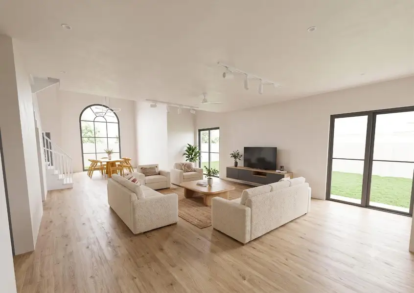 Warm wood flooring and high ceilings define this open, airy living space.