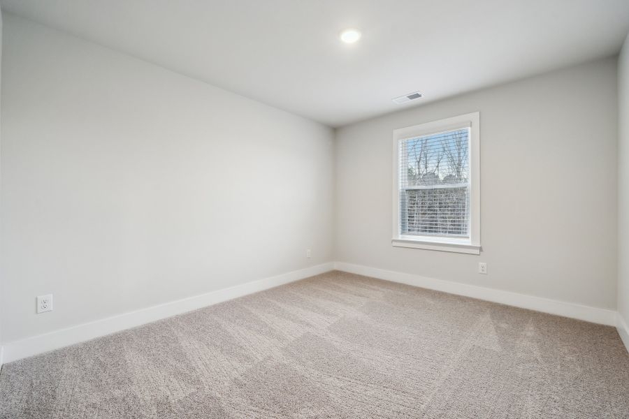 A room with a window and a carpet. A room with a window and a carpet.