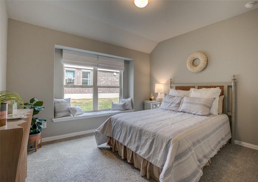 Bedroom with vaulted ceiling and carpet floors Bedroom with vaulted ceiling and carpet floors