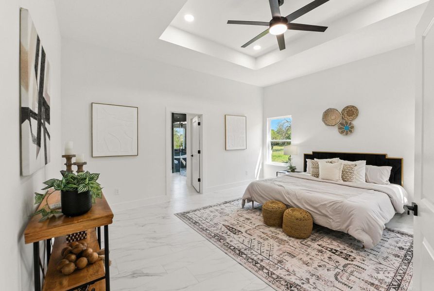 Primary bedroom featuring tile finish floors, and a walk in closet