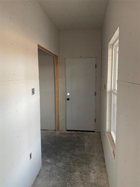 Hall with concrete floors, Laundry is on the Left