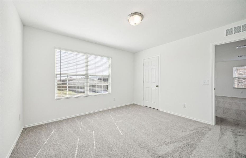 Spacious secondary bedroom with large windows Spacious secondary bedroom with large windows