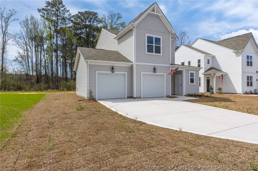 Front exterior of a new home in Pembroke, Hope Mills, NC, highlighting curb appeal (Image 19).