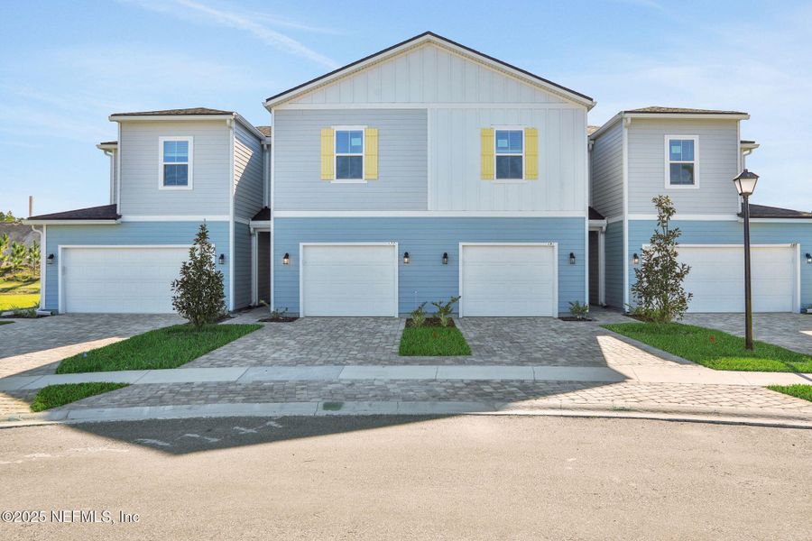 Front exterior of a new home in Brook Forest - Townhomes, St. Augustine, FL, highlighting curb appeal (Image 2).