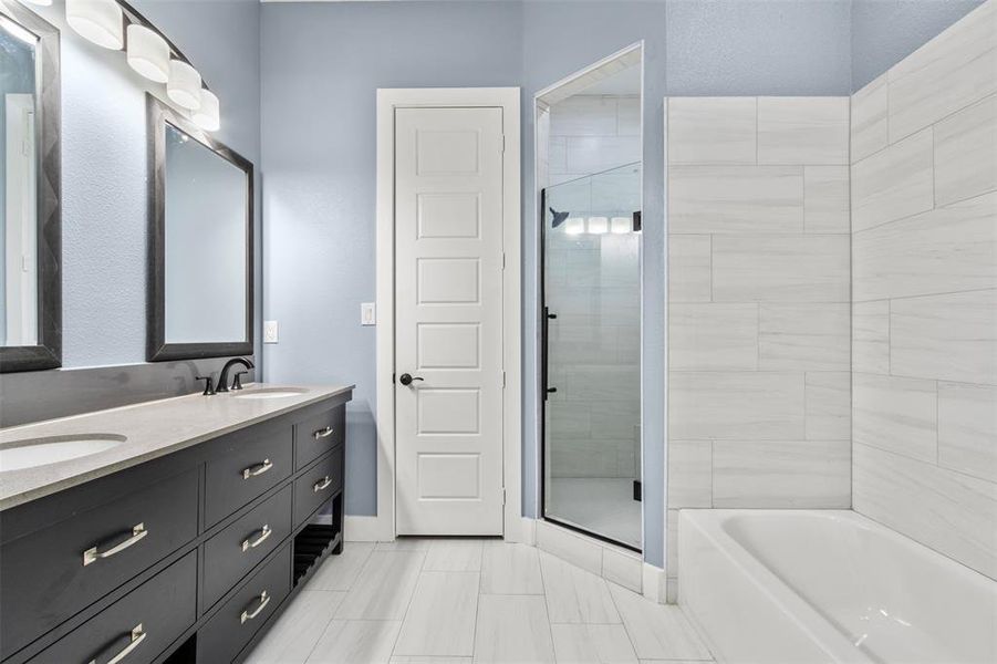 Bathroom with vanity and shower with separate bathtub