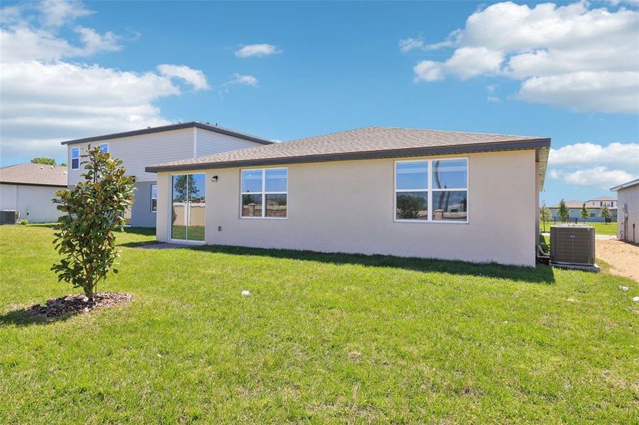 Front exterior of a new home in Lawson Dunes - Signature Series, Haines City, FL, highlighting curb appeal (Image 2). Front exterior of a new home in Lawson Dunes - Signature Series, Haines City, FL, highlighting curb appeal (Image 2).
