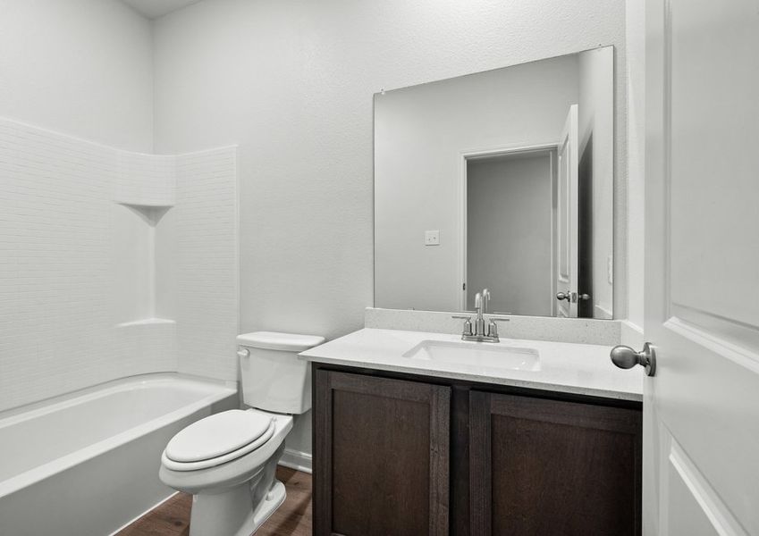 The secondary bathroom has a large vanity and a shower-tub combo. The secondary bathroom has a large vanity and a shower-tub combo.