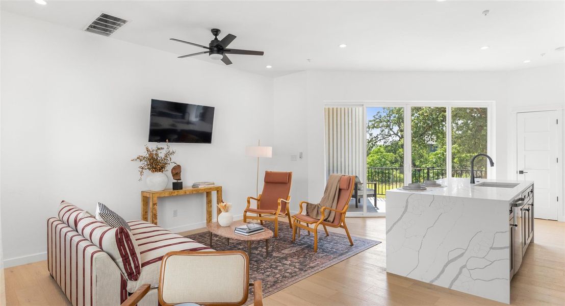 An open, staged living and dining level that shows how naturally the space lends itself to both relaxing and entertaining. Model No. 105 Shown.