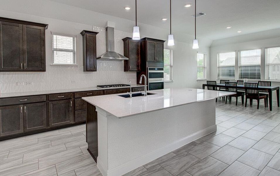 Plentiful cabinetry and a central prep island anchor this well-appointed kitchen layout. Plentiful cabinetry and a central prep island anchor this well-appointed kitchen layout.