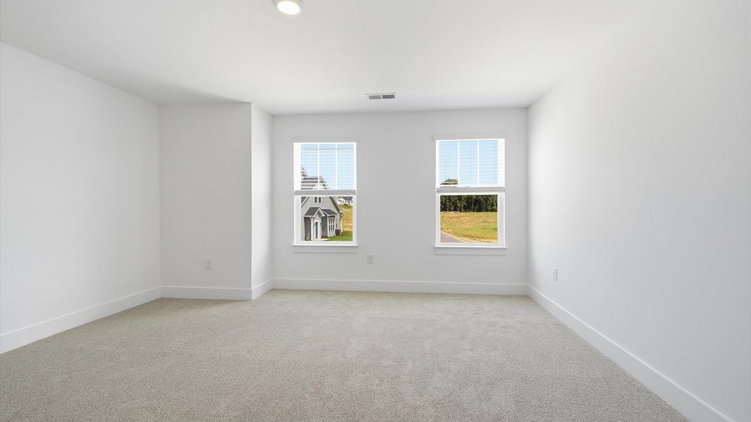 Vibrant and restful bedroom with oversized windows, refined detail, and a warm, welcoming atmosphere by DRB Homes Vibrant and restful bedroom with oversized windows, refined detail, and a warm, welcoming atmosphere by DRB Homes